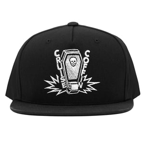 One wheel coffin slapping pavement with a polyurethane skateboard wheel! Skull casket and action embroidered to a black snapback cap.